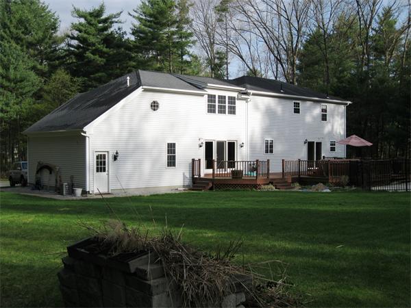 83 Pequot Road Southampton, MA 01073 - Photo 3 of 23 a view of a white house in front of a big yard with large trees