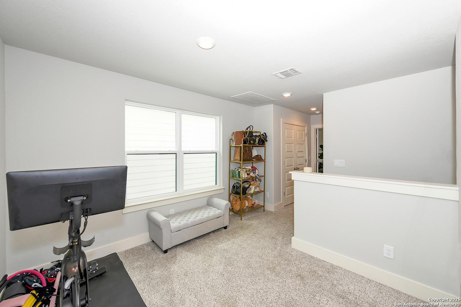 16011 Babcock Road, Unit 13 San Antonio, TX 78255 - Photo 14 of 25 a living room with furniture and a window