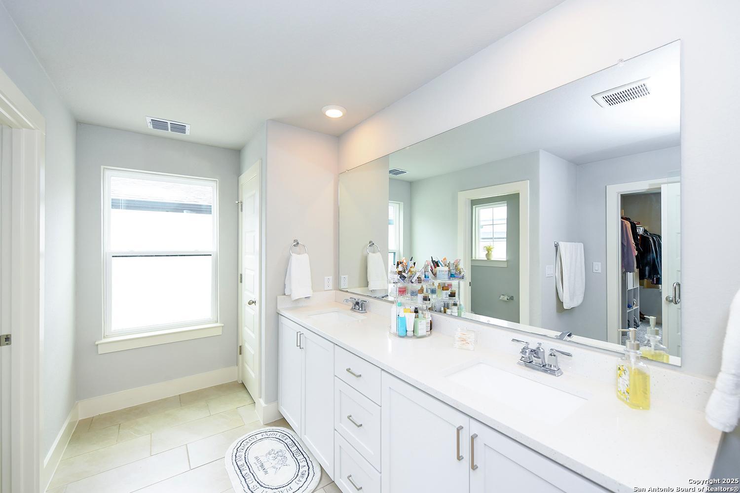 16011 Babcock Road, Unit 13 San Antonio, TX 78255 - Photo 17 of 25 a bathroom with a double vanity sink mirror and