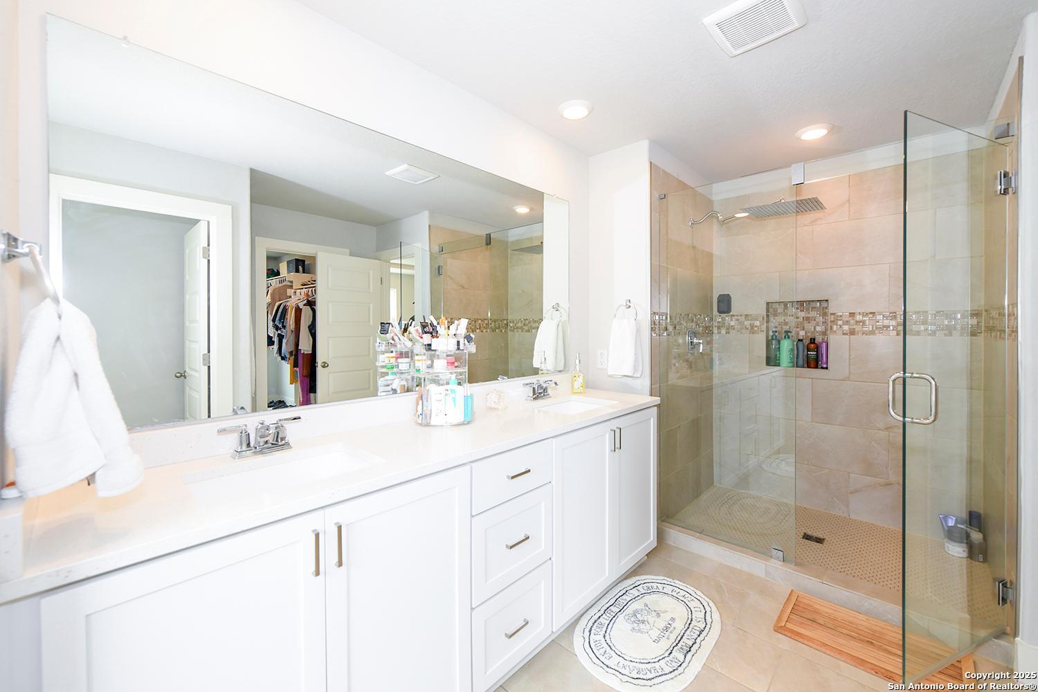 16011 Babcock Road, Unit 13 San Antonio, TX 78255 - Photo 18 of 25 a bathroom with a shower sink and mirror