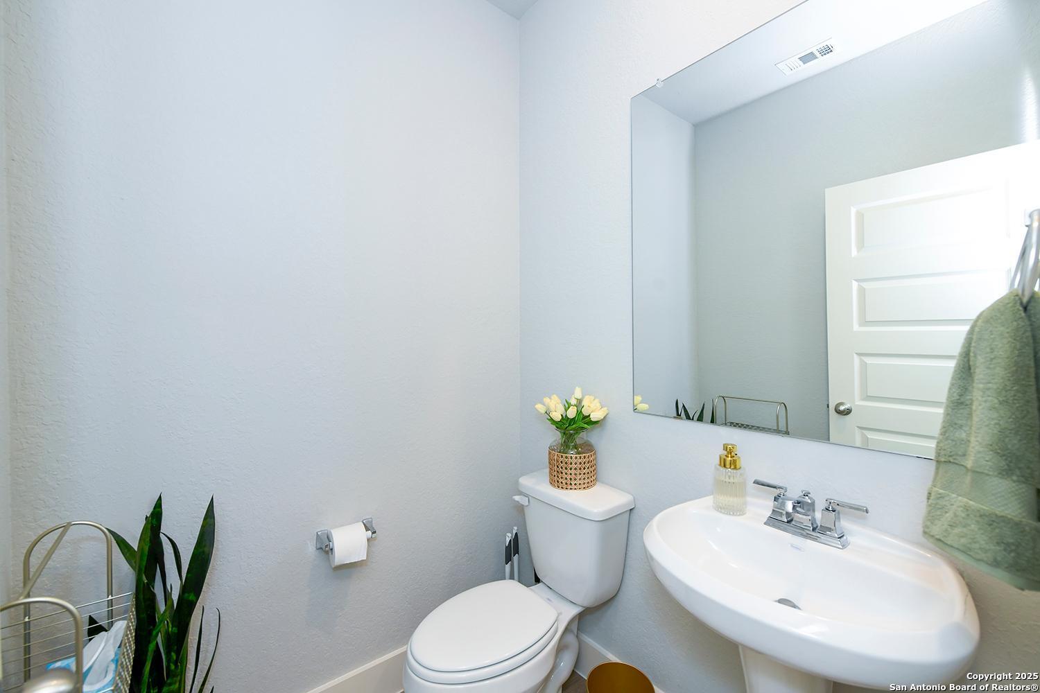 16011 Babcock Road, Unit 13 San Antonio, TX 78255 - Photo 19 of 25 a white toilet sitting next to a bathroom sink