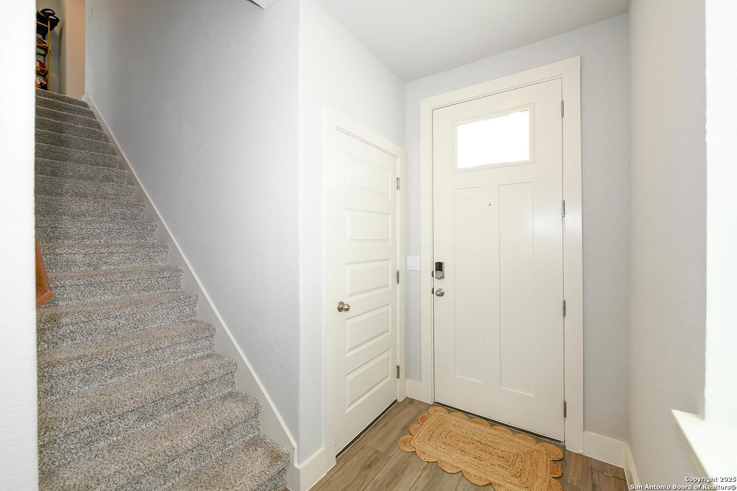 16011 Babcock Road, Unit 13 San Antonio, TX 78255 - Photo 3 of 25 a view of a hallway with wooden floor and entryway
