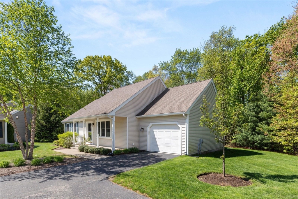 60 Brewster Road, Unit 60 Stoughton, MA 02072 - Photo 14 of 18 a front view of a house with a yard