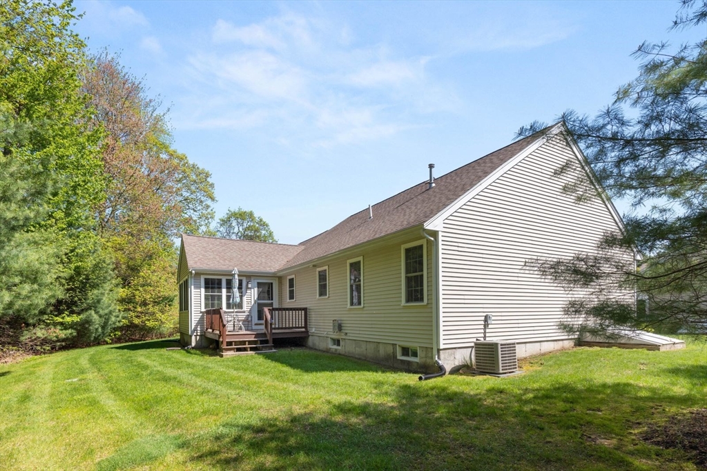 60 Brewster Road, Unit 60 Stoughton, MA 02072 - Photo 16 of 18 a view of a house with a yard and sitting area