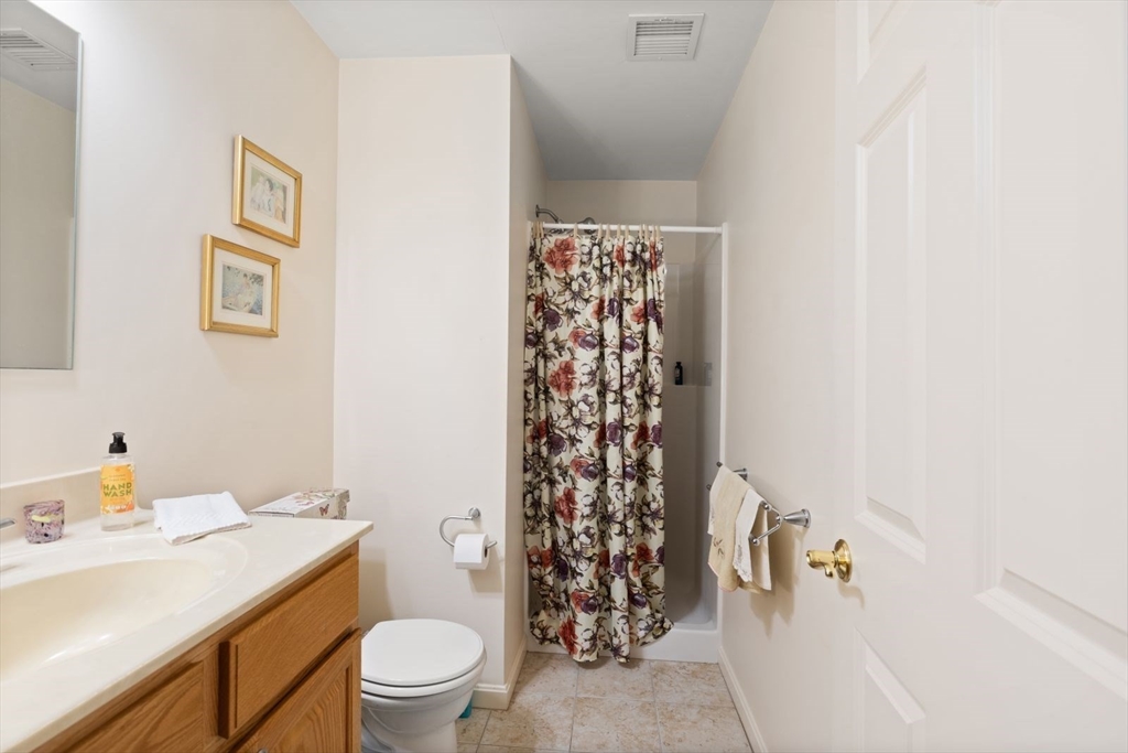 60 Brewster Road, Unit 60 Stoughton, MA 02072 - Photo 8 of 18 a bathroom with a sink toilet and shower