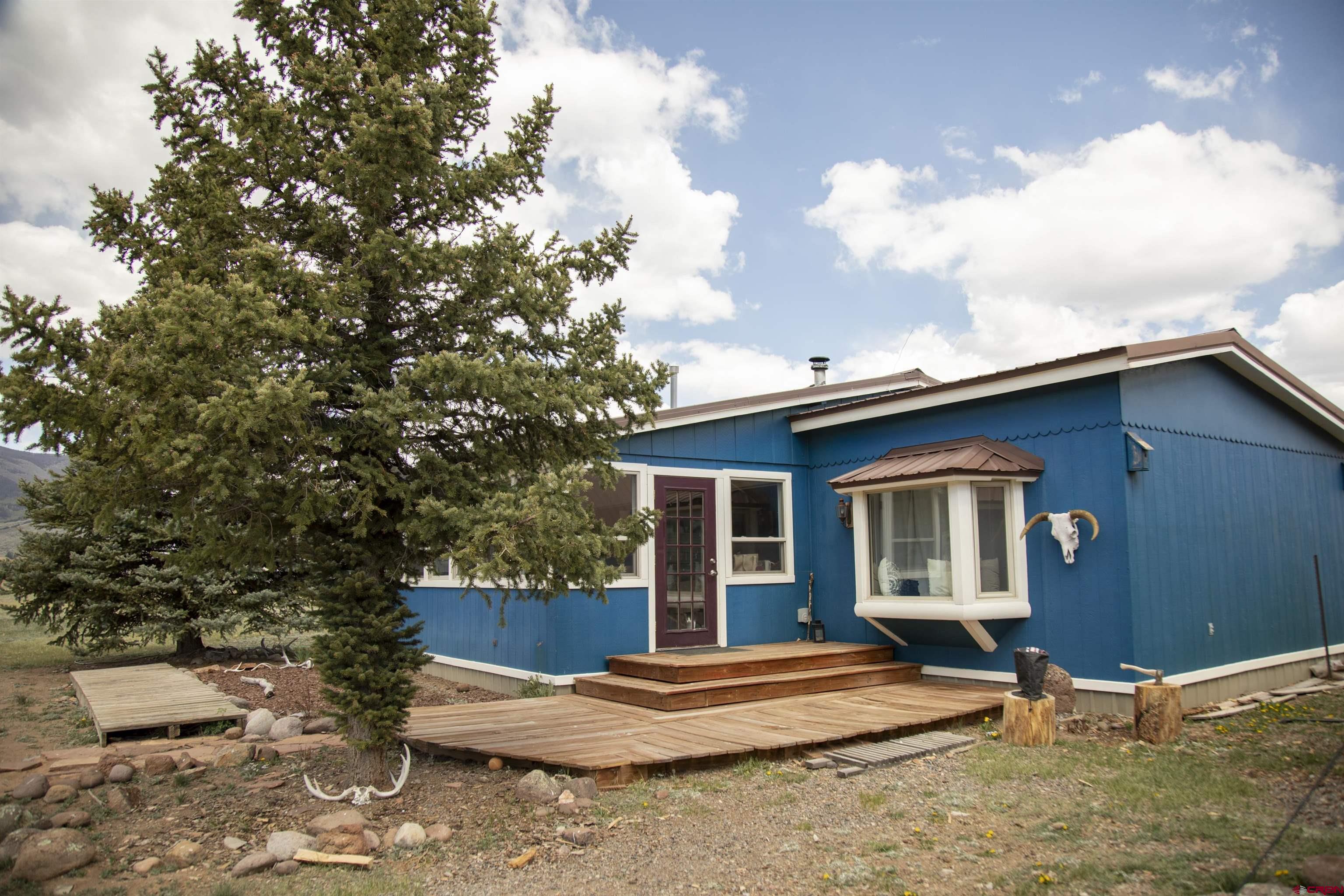 507 Ridge Drive Creede, CO 81130 - Photo 16 of 31 a view of house with backyard and seating area