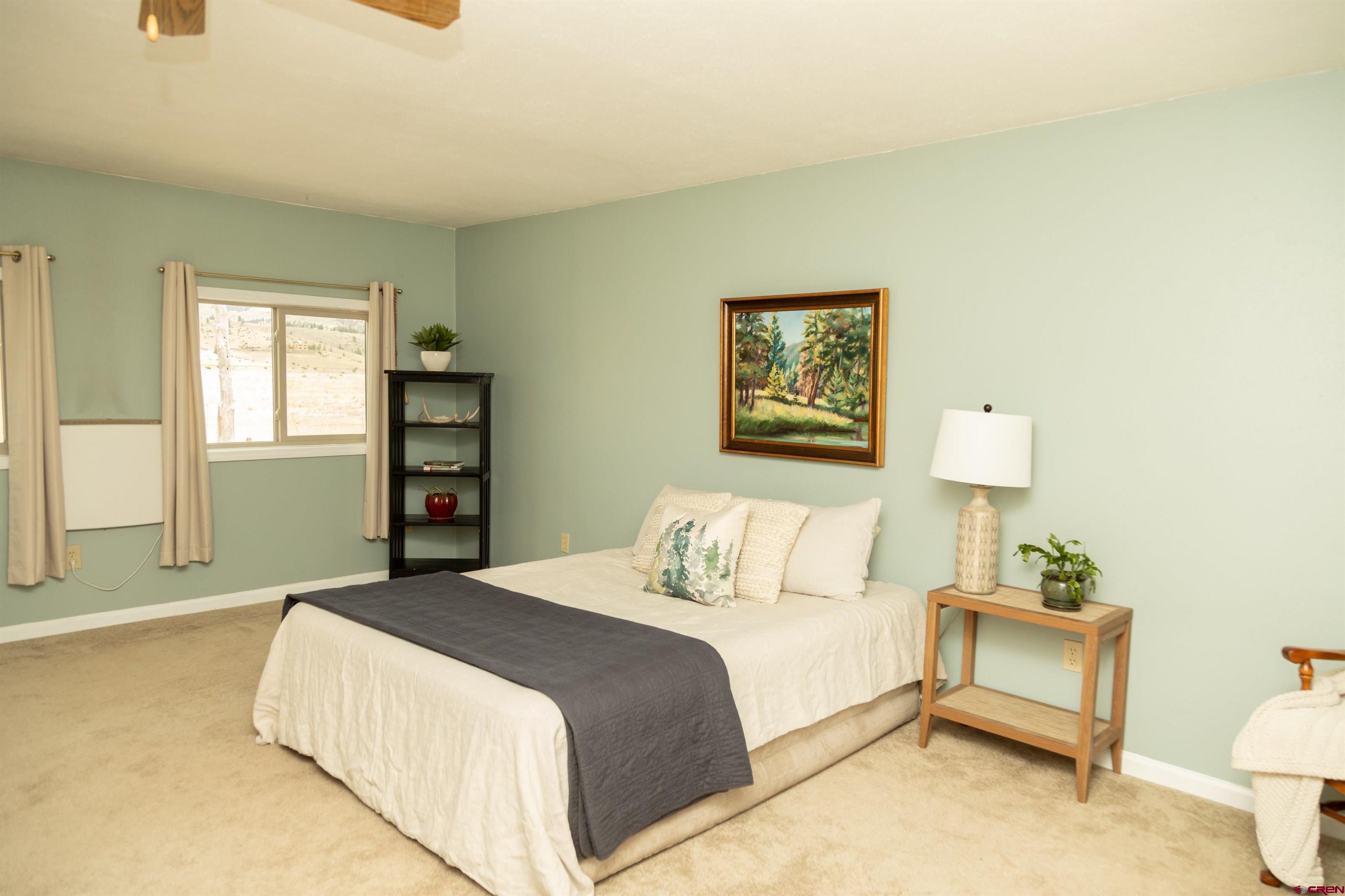 507 Ridge Drive Creede, CO 81130 - Photo 17 of 31 a bedroom with a bed and a night stand