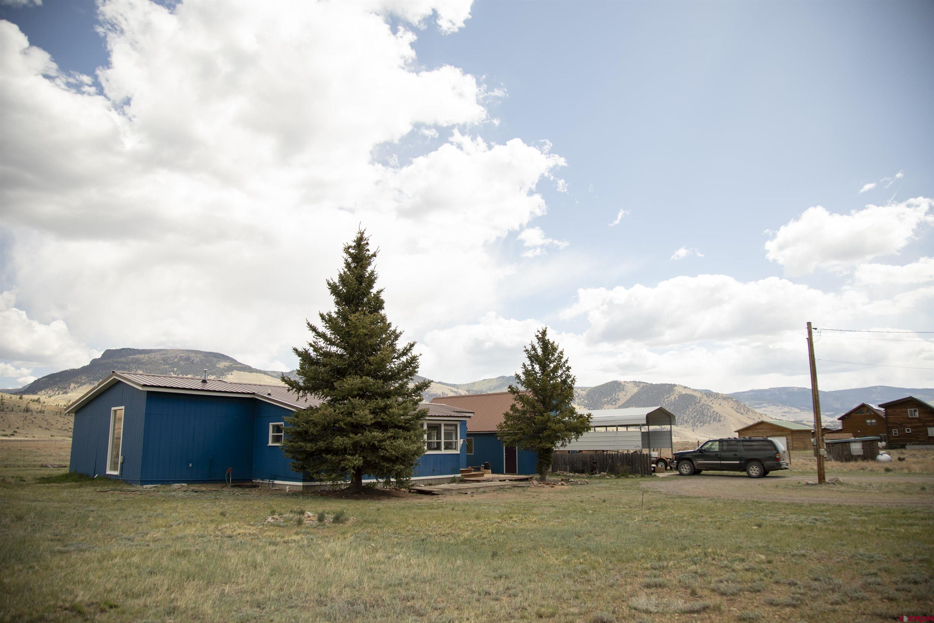 507 Ridge Drive Creede, CO 81130 - Photo 23 of 31 a view of a house with a big yard and large trees