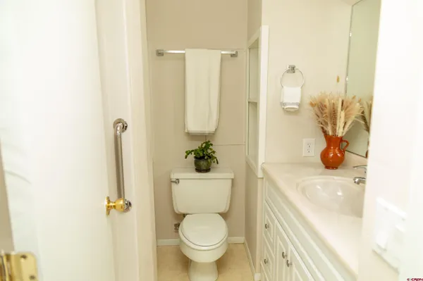a white toilet sitting next to a bathroom sink