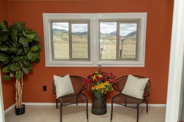 a dining room with furniture and window