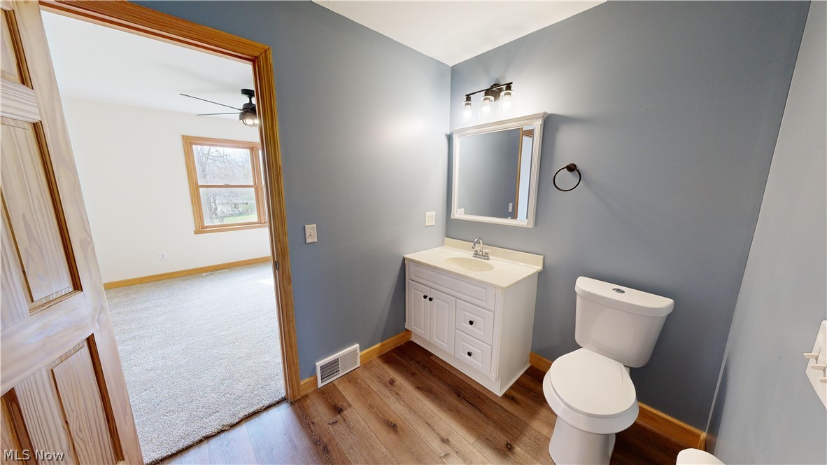 15548 Trask Road Thompson, OH 44086 - Photo 23 of 31 Second floor full bathroom featuring ceiling fan, toilet, vanity, and hardwood / wood-style flooring