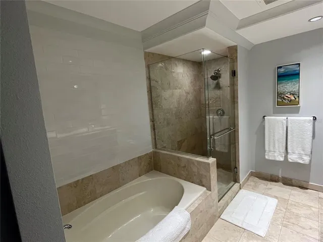 a bedroom with bed couch and window