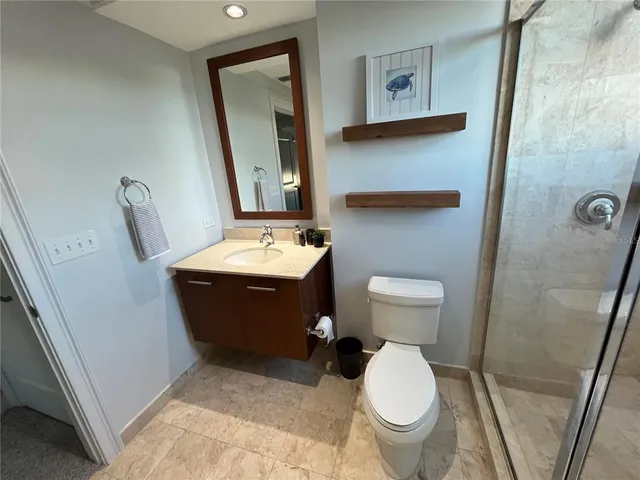a bathroom with a sink toilet and shower
