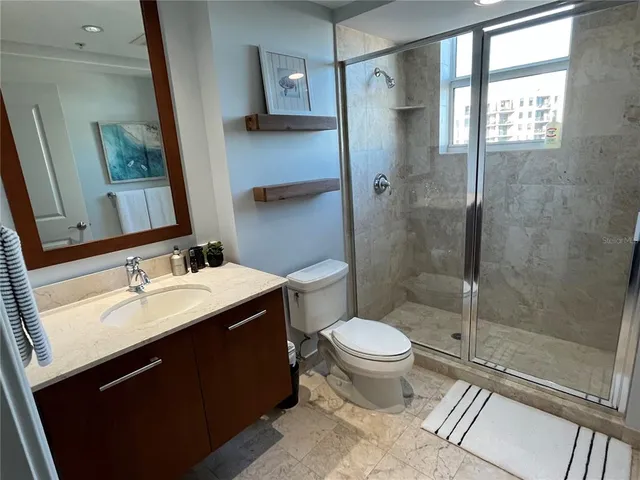a bathroom with a shower and toilet