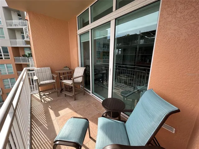 a balcony with table and chairs