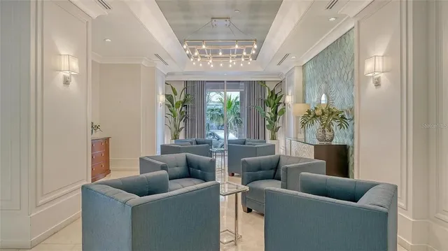 a living room with furniture and a book shelf