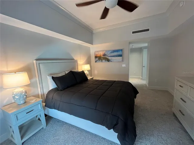 a bedroom with a bed and a ceiling fan