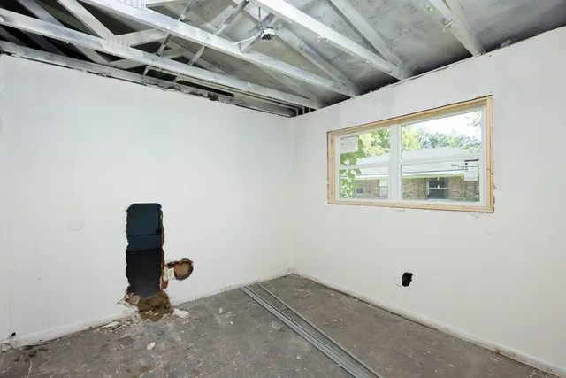 a room with gym equipment and a window