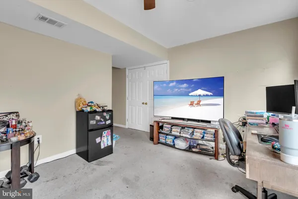 a view of a workspace with furniture and a flat screen tv