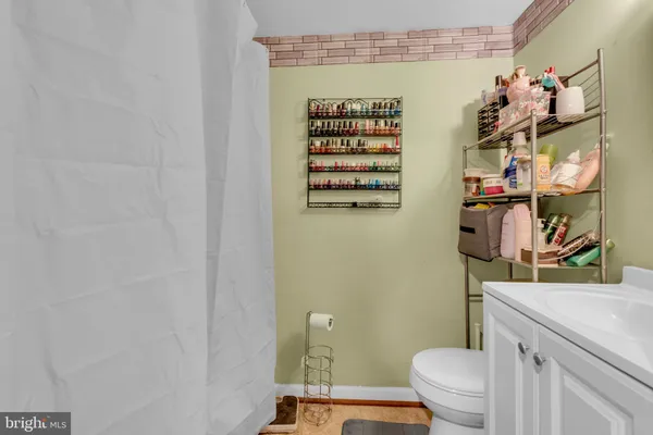 a bathroom with a toilet and a shower curtain