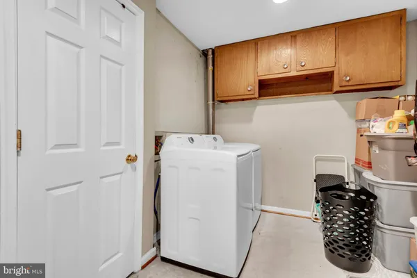 a utility room with closet dryer and washer