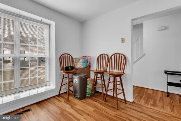 a view of a room with wooden floor and windows