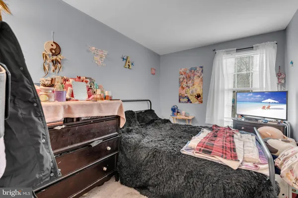 a bedroom with a bed and dresser