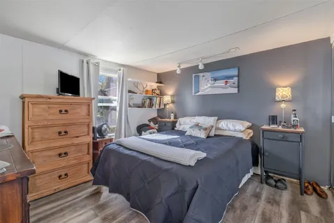 a bedroom with a bed and a television