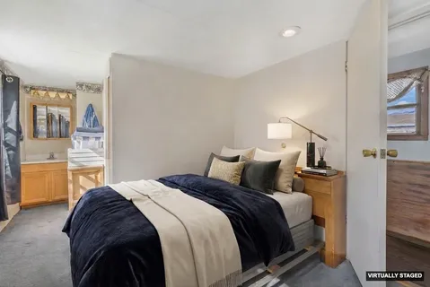 a bedroom with a bed and wall painting