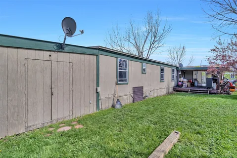 a view of a house with backyard and sitting area