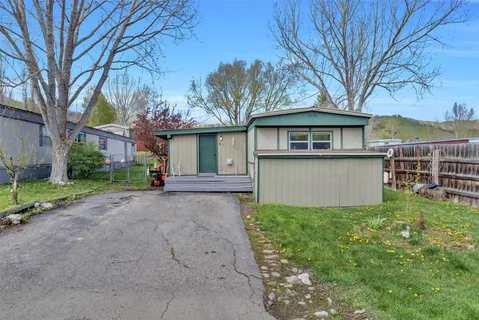 a front view of a house with yard and green space