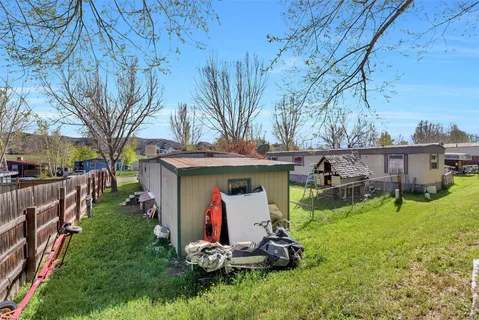 a view of a backyard with table and chairs