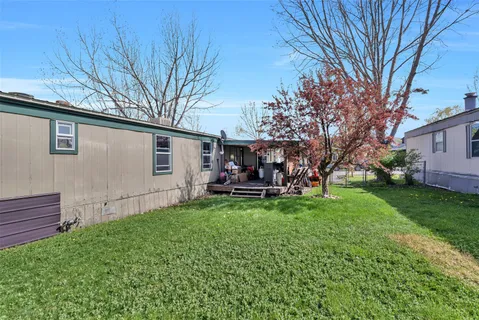a view of a house with backyard and sitting area