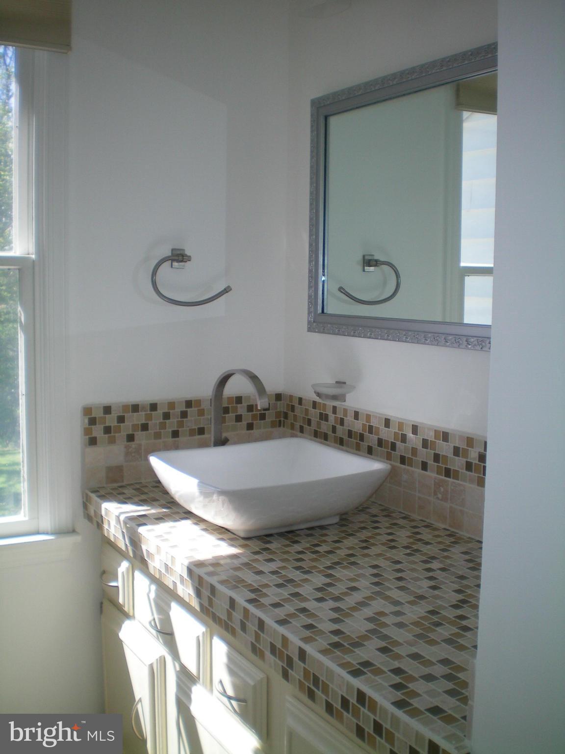 282 Fairhaven Road Tracys Landing, MD 20779 - Photo 12 of 30 a bathroom with a granite countertop sink a mirror and vanity
