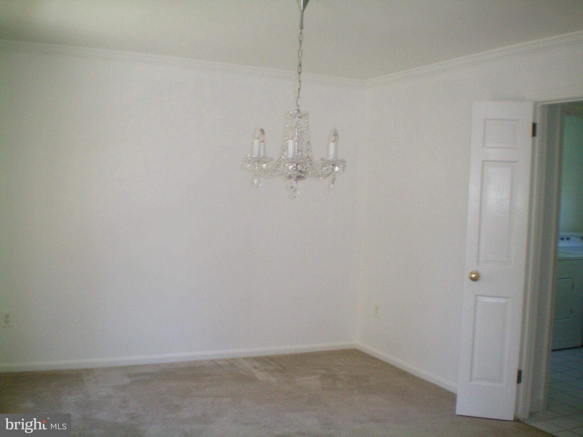 282 Fairhaven Road Tracys Landing, MD 20779 - Photo 17 of 30 a room with a chandelier fan and wooden floor
