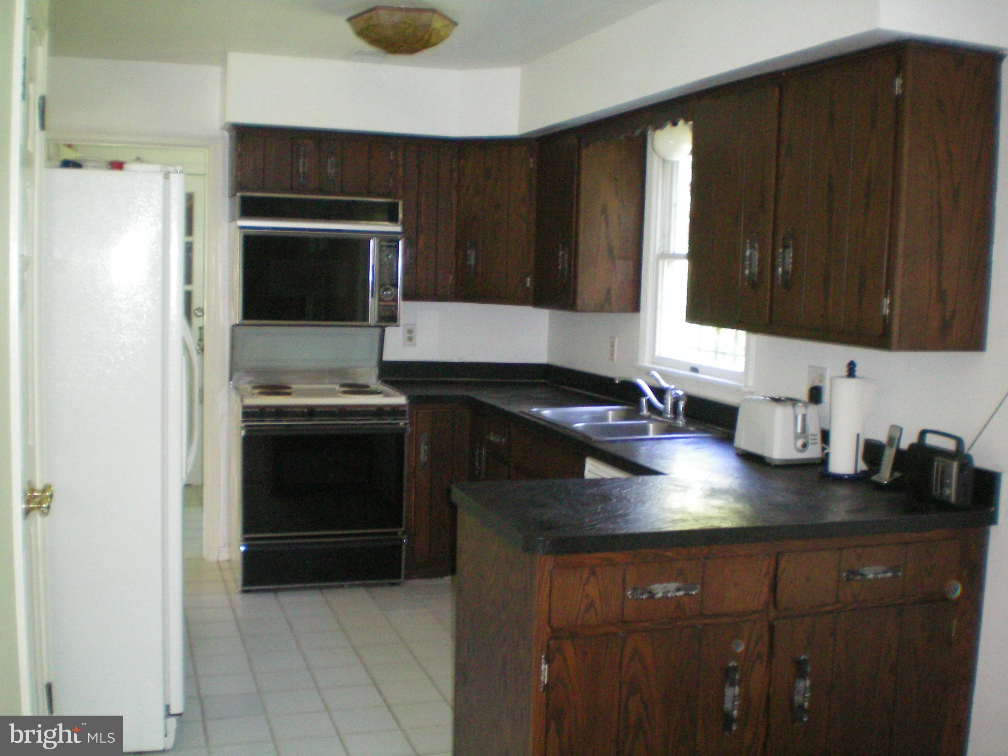 282 Fairhaven Road Tracys Landing, MD 20779 - Photo 6 of 30 a kitchen with a sink and cabinets
