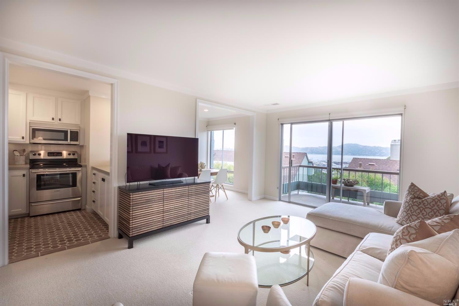 73 Anchorage Road Sausalito, CA 94965 - Photo 1 of 1 a living room with furniture and a flat screen tv