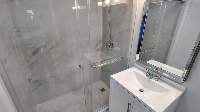 a bathroom with a sink toilet and shower