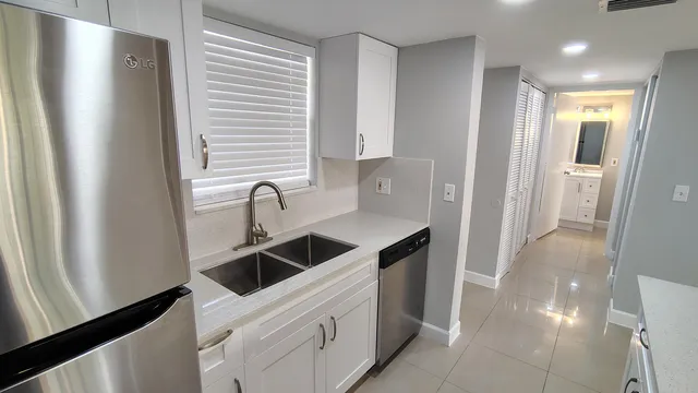 a kitchen with stainless steel appliances a refrigerator and a sink