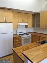 a kitchen with a stove and a refrigerator