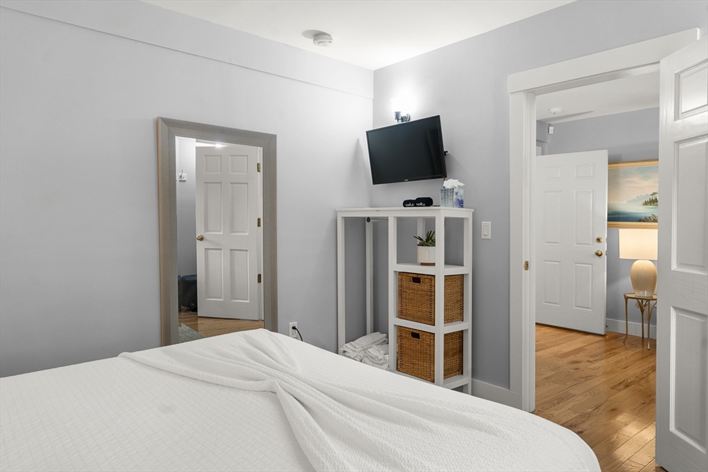4 Hye Lane Edgartown, MA 02539 - Photo 24 of 41 a bedroom with a bed and a flat screen tv