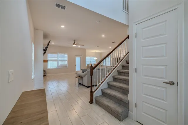 a view of entryway and hall with wooden floor