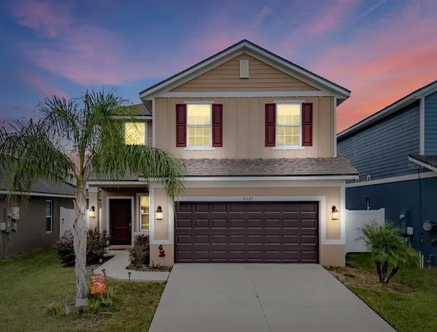 a front view of a house with a yard and garage