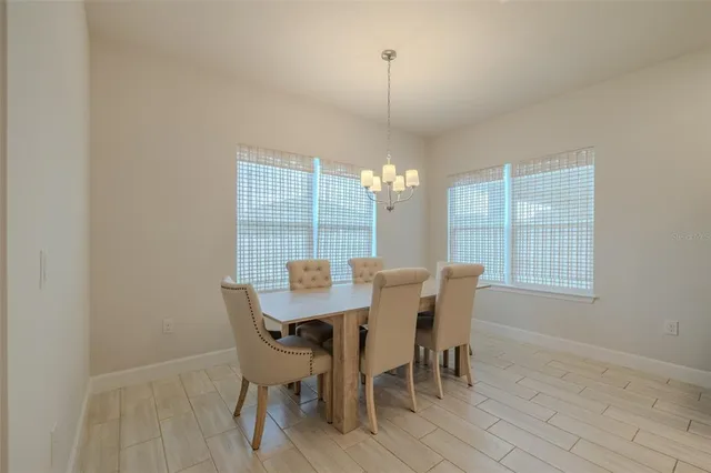 a view of a dining room with furniture and chandelier