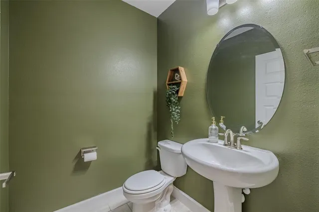 a bedroom with a bed lamp and a chandelier