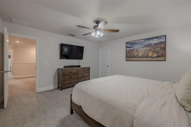 a bathroom with a granite countertop sink a toilet and a mirror
