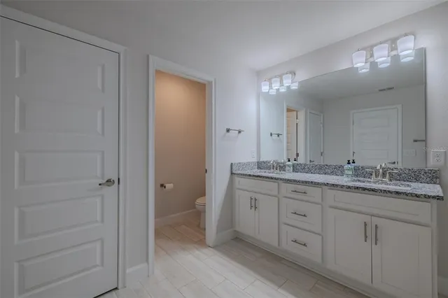 a bedroom with a bed a dresser and a window