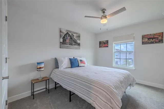 a bedroom with a bed and a painting on the wall