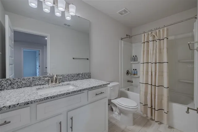 a view of a bedroom with cabinets