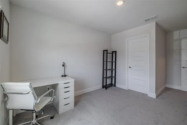 a view of room with lounge chair and windows